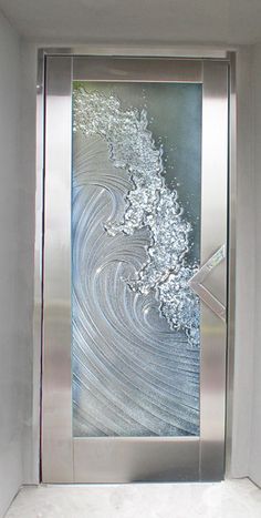 an artistic glass door in the corner of a room