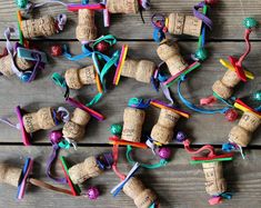 wine corks are tied together with colorful ribbons and beads on a wooden table top