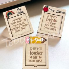 three wooden magnets with different sayings on them and an apple in the background