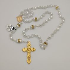 "A beautiful rosary made of high quality pearl beads. Fully handcrafted with each bead individually cut, polished and drilled by expert craftsmen. This rosary is not only a long lasting piece of jewellery but also the perfect gift for yourself or someone special in your life. The Our Lady Fatima with the three Little Shepherds at Her feet Center on one side and water from the fountain of the Sanctuary of Fatima on the other.  With this special center piece and the very original Crucifix makes th Polished Round Beads Rosary For Jewelry Making, Elegant Rosary With 8mm Beads And Crucifix, Silver Pearl Rosary With 8mm Beads, Elegant Pearl Rosary With Cross, Elegant Pearl Beaded Rosary, Spiritual Pearl Rosary With 8mm Beads, Spiritual Pearl Rosary As Gift, Elegant Beaded Rosary For Jewelry Making, Elegant Pearl Rosary With 8mm Beads