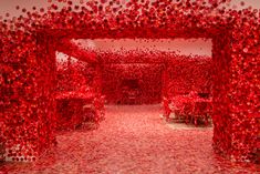 a room filled with lots of red objects in the middle of it's walls