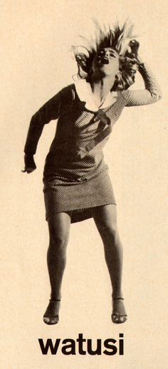 a woman is jumping up in the air with her hair flying above her head while wearing a skirt