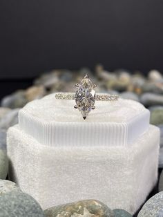 a diamond ring sitting on top of a white box