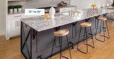 a kitchen island with stools in front of it and an area for seating to sit at