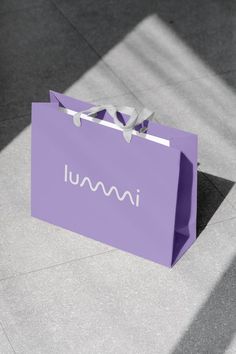 a purple shopping bag with the word ummu written on it sitting on the ground