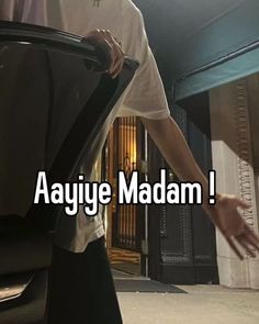 an image of a man holding the door to his car that says aayiye madam