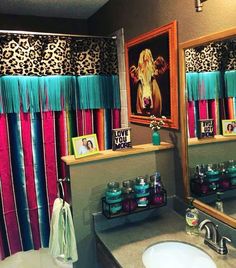 the bathroom is decorated with colorful shower curtains