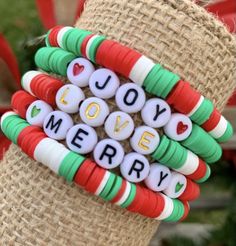 some type of bracelet that says love, merry on it and is decorated with candy