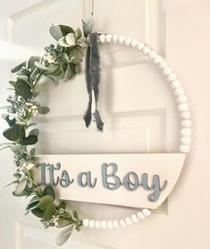 a door hanger that says, it's a boy