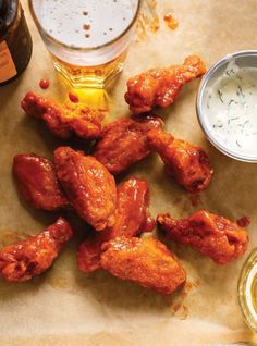 chicken wings and beer are on the table