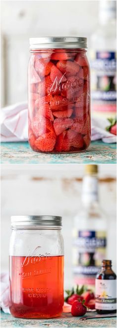 two jars filled with strawberries sitting on top of a table next to each other