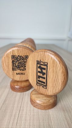 two wooden mallets with qr code on them sitting on top of a table