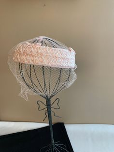 "Pink Wedding Halo Hat with Veil, Women's Birdcage Vintage Fashion Veiled Mini Raffia Hat, MCM Crown Hat, Church Lady Hat Lovely woven raffia outer with pink velvet bow accent. This is a crown or halo hat with a fabric base, woven raffia detail. The netting is in great condition, no tears. It is placed a little longer in the front. Very well made and cared for. No label. Inside circumference: 22\". Made in the age of hats! No label. No obvious defects, tears or holes. Thank you for looking. This Adjustable Pinched Crown Headpiece For Garden Party, Adjustable Costume Hat With Structured Crown For Garden Party, Adjustable Hat For Ceremony, Adjustable Hat Headpiece For Ceremonies, Adjustable Wedding Bonnet For Spring, Fitted Vintage Pink Headpiece, Vintage Fitted Pink Headpiece, Vintage Pink Fitted Headpieces, Adjustable Cloche Hat For Ceremony