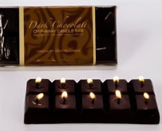 chocolate bar with lit candles in front of it and packaged package on the side for display