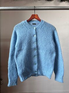 "1960s blue knit cardigan. Good vintage condition.  18\" Pit to pit  22\" Length All sales final, please ask any questions before buying. Thanks!" Classic Light Blue Winter Sweater, Retro Blue Cardigan For Winter, Blue Wool Knitted Cardigan, Blue Knitted Wool Cardigan, Blue Wool Sweater With Buttons, Blue Fitted Crew Neck Cardigan, Fitted Blue Crew Neck Cardigan, Blue Cozy Knitted Cardigan, Blue Sweater Cardigan