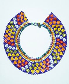 a multicolored beaded collar necklace on a white background with space for text