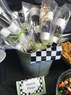 a table topped with lots of different types of candy and snacks in plastic wrappers