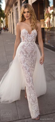 a woman is walking down the street in a wedding dress