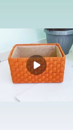 an orange basket sitting on top of a table