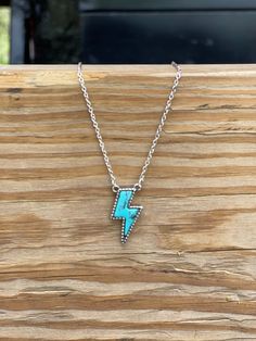 Looking to add a pop of turquoise to your jewelry collection? This Lightning Bolt Stone Necklace can add a bit of flash to any western inspired outfit! It features a silver chain with a turquoise stone bordered with a silver accent. Light up any look with this bolt of color. Faux silver and turquoise Cheap Turquoise Summer Jewelry, Cheap Turquoise Necklace, Cheap Turquoise Necklaces For Festivals, Cheap Turquoise Necklace For Festivals, Lightning Jewelry, Punchy Jewelry, Western Jewelry Necklace, Western Jewerly, Western Fashion Jewelry