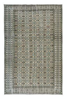 an antique rug with blue and beige colors