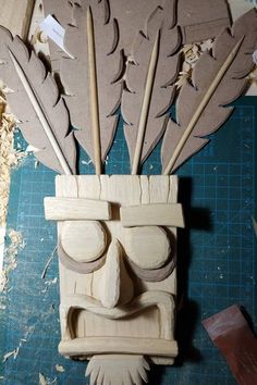 a wooden mask made to look like feathers