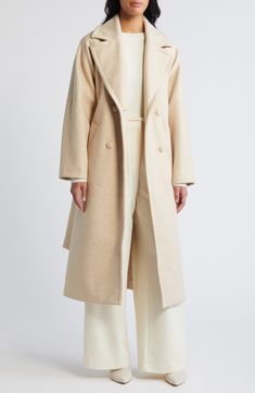 Wool-kissed double-face fabric brings cozy comfort to this lengthy belted coat crafted in a double-breasted silhouette framed with notched lapels. 47" length (size medium) Double-breasted button closure Notched lapels Front welt pockets Removable tie belt Lined 86% polyester, 7% wool, 7% rayon Dry clean Imported Chic Neutral Belted Outerwear, Cream Colored Long Coat With Belt, Cream Belted Long Coat, Cream Long Coat With Belt, Chic Beige Outerwear With Shawl Collar, Cream Double-breasted Outerwear With Notch Lapel, Beige Long Wool Coat With Belted Cuffs, Cream Double-breasted Outerwear For Fall, Cream Double-breasted Long Coat