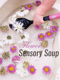 a baby in a bathtub with flowers on it and the words flower sensory soap