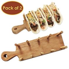 three tacos are lined up on a cutting board and ready to be cut into smaller pieces