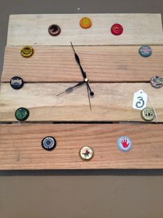 a clock made out of wooden planks with different types of buttons on the sides