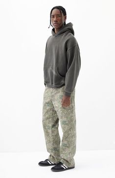 Embrace rugged style with PacSun's Tree Camo Baggy Cargo Jeans, featuring a camo print throughout and crafted from rigid, sustainably sourced cotton. These jeans offer a wide leg and a baggy fit, complete with cargo details at the leg for added utility and unique style. Ideal for those seeking durability and standout design in their wardrobe choices.Model is wearing size 32Model Measurements: 6'0” Height, 28" Waist, 34” Chest, 32” HipsLearn more about PacSun eco items PacSun Mens Tree Camo Baggy Camo Pants Outfit Aesthetic, Relaxed Fit Camouflage Cargo Pants For Fall, Rugged Cargo Pants With Cargo Pockets For Streetwear, Rugged Relaxed Fit Bottoms For Streetwear, Relaxed Fit Camouflage Cotton Cargo Pants, Streetwear Fashion Men Fall, Camouflage Outfits Men, Camo Cargo Pants Outfit Men, Camo Pants Outfit Men Streetwear