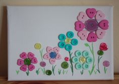 a painting with buttons and flowers painted on it