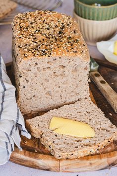 a loaf of bread sitting on top of a wooden cutting board