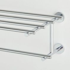 two chrome towel racks mounted to the wall