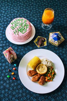 a white plate topped with food next to a cake