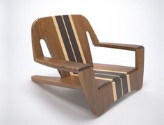 a chair made out of wood with stripes on the seat and back, sitting in front of a white background