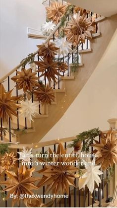 a staircase decorated with paper flowers and greenery