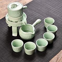 a group of green cups sitting on top of a mat