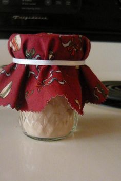 a glass jar filled with whipped cream sitting on top of a counter