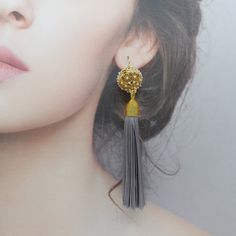 Add a touch of elegance to any outfit with these handmade earrings featuring a gold plated brass filigree locket with faux pearls and aquamarine tassels. Made with a long lasting gold plating layer and based on an ancient Chinese recipe, the herb beads in the locket are made in Taiwan with generations of heritage in traditional Chinese medicine using 100% plant-based ingredients with unique properties to enhance wellness. These earrings feature vermeil ear wires and are made to order in a size o Elegant Handmade Silver Tassel Earrings, Elegant Beaded Tassel Earrings, Elegant Gold Jewelry With Tassels, Elegant Gold Tassel Jewelry, Elegant Gold Tassel Earrings With Latkans, Bohemian Gold Tassel Earrings For Wedding, Gold Bohemian Tassel Earrings For Wedding, Elegant Gold Tassel Earrings As Gift, Elegant Gold Tassel Earrings For Gift