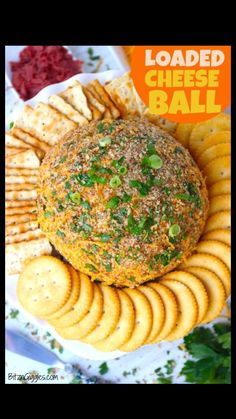 loaded cheese ball on a plate with crackers and garnishes around it