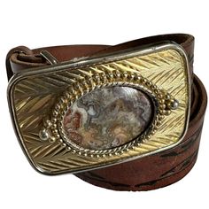 You are looking at a genuine gold tone buckle with  lovely polished stone.   The buckle measures 2"8 wide X 1"7 high. The cowhide leather belt is size 34-36 by Levis and measures 40"5 long with 30"8 on first perforation from buckle with 36"8 on last perforation and 1"4 wide. The overall condition of this belt is good and there are a few light scuffs with no tears and the leather is nice and strong.  Items are sold as is and if you have an questions please let me know before you purchase item.  S Western Vintage, Suspender Belt, Vintage Western, Belt Size, Suspenders, Cowhide Leather, Leather Belt, Levi's, Gold Tones