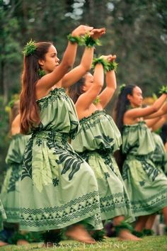 some women in green dresses are dancing together