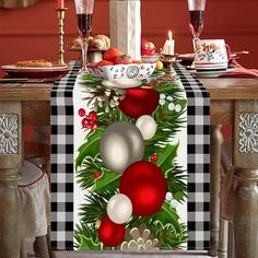 a christmas table runner with ornaments and baubles on it, sitting at a dining room table