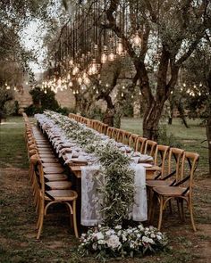 a long table set up for an outdoor dinner