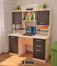 a computer desk with a laptop sitting on top of it next to a green chair