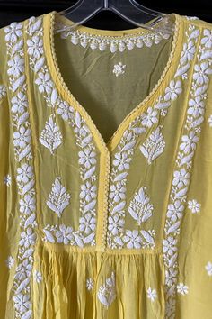 This comfy and beautiful Yellow Gold Lucknowi Hand Embroidered Chikankari Short Frock A-Line Peplum Kurta Pant Set is perfect for any event. Handwork embroidery adorns the front, back, and sleeves, and a Croatia border lace adds a touch of elegance. Included wide-leg pants come with handwork embroidery and a convenient elastic waist band. 2 Piece Muslin Cotton Kurta length 36" inches Sleeves length 18" inches A line Bottom length 39" inches Elastic/drawstring waist Side-seam pockets Croatia bord Yellow Anarkali Kurta With Floral Embroidery, Spring Festive Sharara With Cutdana, Spring Traditional Long Sleeve Wear With Dori Work, Traditional Spring Sharara With Cutdana, Traditional Cutdana Sharara For Spring, Traditional V-neck Kurta With Chikankari Embroidery, Spring Salwar Kameez With Dori Work, Festive V-neck Kurta With Chikankari Embroidery, Traditional Chanderi V-neck Dress