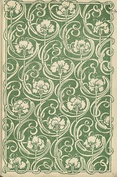 an old book with green and white designs on the front cover, which is surrounded by swirls and flowers