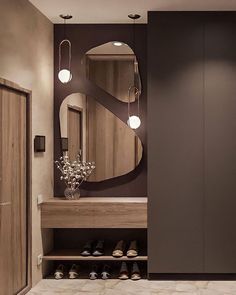 a bathroom with a large mirror on the wall next to a wooden cabinet and shelf