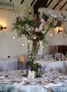 the table is set with flowers and place settings